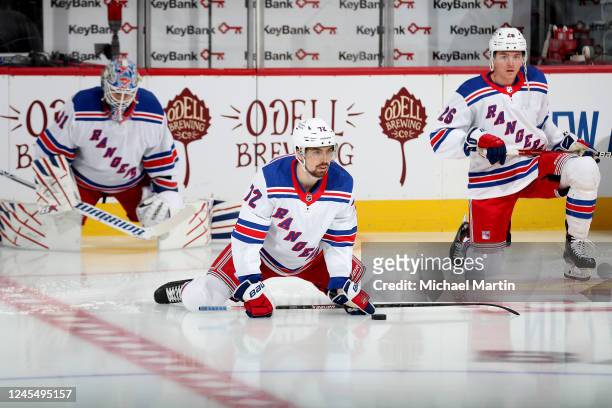 Goaltender Igor Shesterkin, Filip Chytil and Jimmy Vesey of the New York Rangers stretch prior to the game against the Colorado Avalanche at Ball...