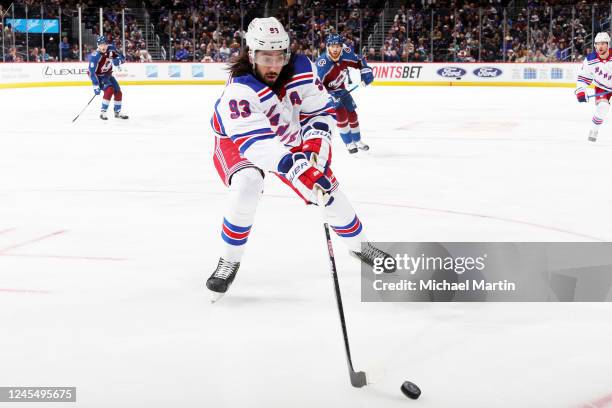 Mika Zibanejad of the New York Rangers reaches for a loose puck in the first period against the Colorado Avalanche at Ball Arena on December 9, 2022...