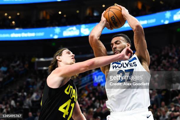Rudy Gobert of the Minnesota Timberwolves rebounds over Kelly Olynyk of the Utah Jazz during the first half of a game at Vivint Arena on December 09,...