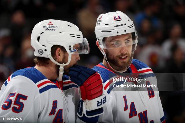 Ryan Lindgren and Barclay Goodrow of the New York Rangers talk during a pause in play against the Colorado Avalanche at Ball Arena on December 9,...