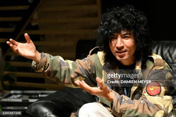 Uyghur artist and member of None Sounds electronic duo Aishan Rock gestures during a press conference in Rennes, western France, on december 9, 2022....