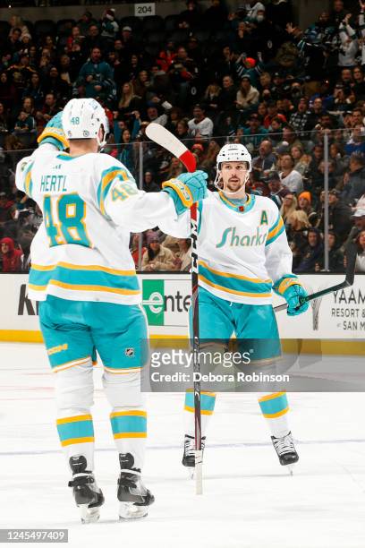 Erik Karlsson of the San Jose Sharks celebrates his goal with Tomas Hertl during the second period against the Anaheim Ducks at Honda Center on...
