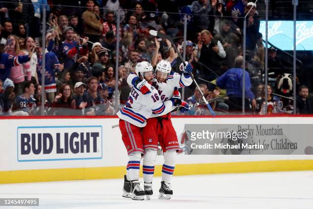 Vincent Trocheck and Artemi Panarin of the New York Rangers celebrate a penalty shootout victory over the Colorado Avalanche at Ball Arena on...