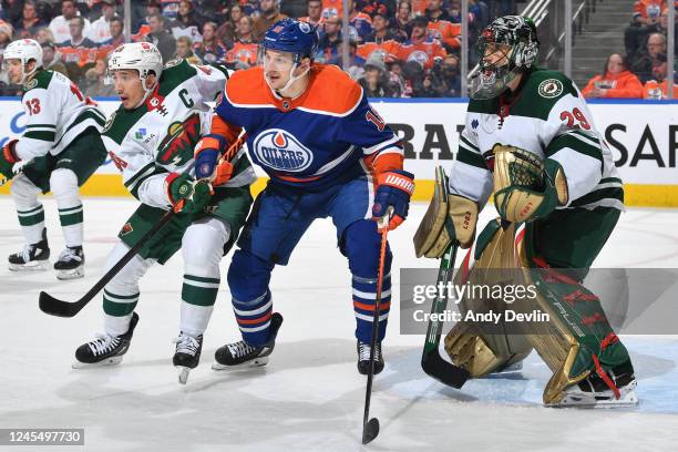 Zach Hyman of the Edmonton Oilers and Jared Spurgeon of the Minnesota Wild battle for position in front of the net during the game on December 9,...