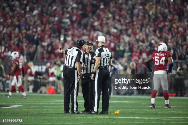 Umpire Jeff Rice and referee Clete Blakeman discuss a call during an NFL NFC Divisional Playoff football game between the Green Bay Packers and the...