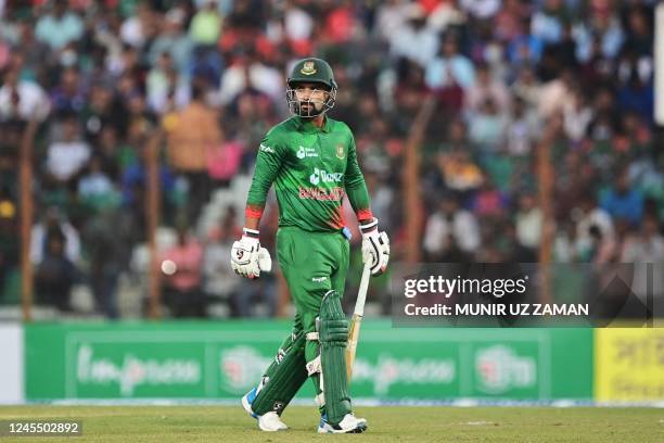 Bangladesh's captain Litton Das walks back to the pavilion after his dismissal during the third and final one-day international cricket match between...