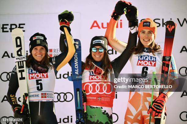 Runner-up Sweden's Sara Hector, winner Italy's Marta Bassino and third-placed Slovakia's Petra Vlhova pose on the podium after the Women's Giant...