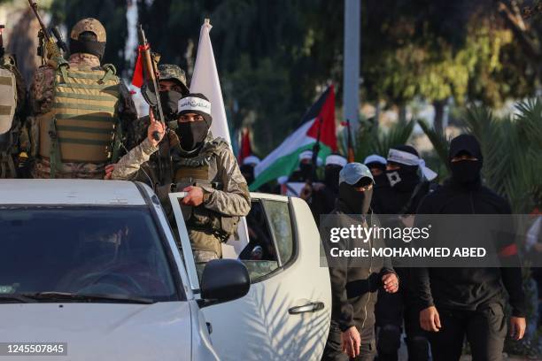 Palestinians Hamas militants wearing headbands reading in Arabic "the Lion's Den", in reference to the Nablus based Lion's Den armed group , a loose...