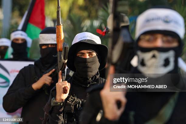 Palestinians Hamas militants wearing headbands reading in Arabic "the Lion's Den", in reference to the Nablus based Lion's Den armed group , a loose...