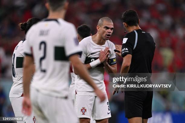 Portugal's defender Pepe argues with Argentinian referee Facundo Tello during the Qatar 2022 World Cup quarter-final football match between Morocco...