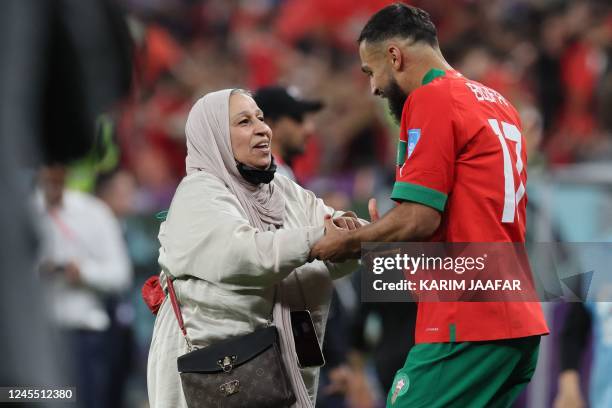 Morocco's midfielder Sofiane Boufal is congratulated by a supporter after his won the Qatar 2022 World Cup quarter-final football match between...