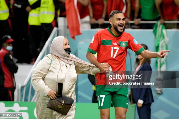 Sofiane Boufal of Morocco celebrates the victory with his mother during the World Cup match between Morocco v Portugal at the Al Thumama Stadium on...