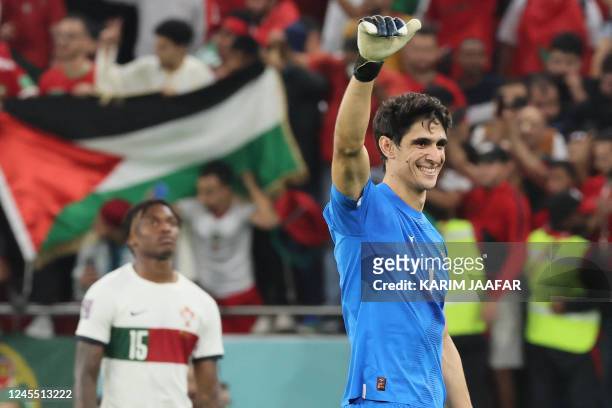 Morocco's goalkeeper Yassine Bounou celebrates with supporters after his team won the Qatar 2022 World Cup quarter-final football match between...