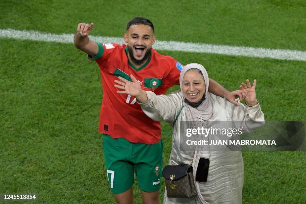 Morocco's midfielder Sofiane Boufal celebrates with his mother after qualifying to the next round by defeating Portugal 1-0 in the Qatar 2022 World...