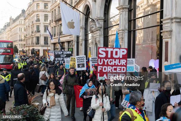 Hongkongers, Tibetans, Uyghur Muslims and their supporters march through central London past the Apple Store against the Chinese Communist Party on...