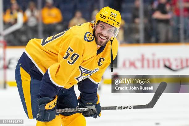 Roman Josi of the Nashville Predators smiles as he looks over at his family during warmups prior to an NHL game against the Ottawa Senators at...