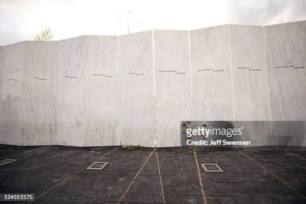 Flowers sit along the Wall of Names at the Flight 93 Memorial for the dedication ceremony, September 10, 2011 in Shanksville, Pennsylvania. The...