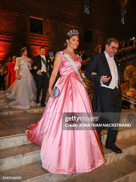 Crown Princess Victoria of Sweden and Nobel Prize laureate in Physics Alain Aspect of France arrive at a royal banquet to honour the laureates of the...