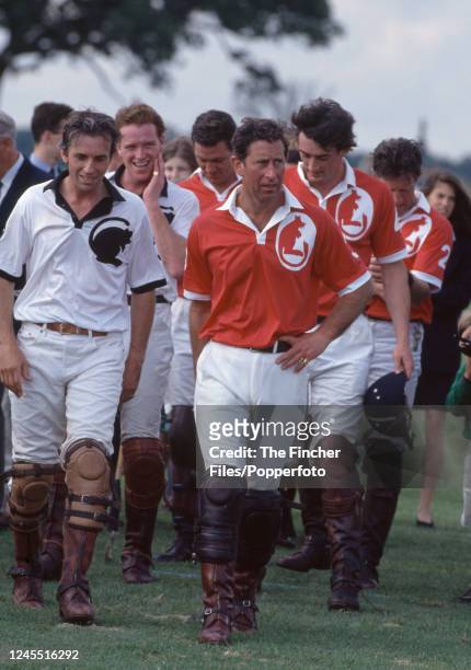 Prince Charles and James Hewitt with their teams following a polo match at the Royal County of Berkshire Polo Club in Cranbourne, England in July,...