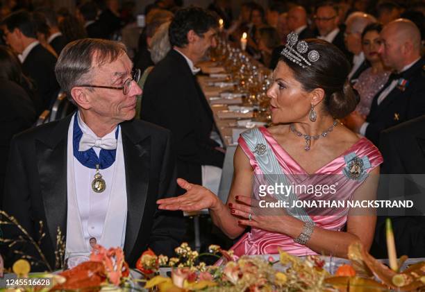 Nobel Prize in Physiology or Medicine 2022 laureate Swedish geneticist Svante Paabo chats with Crown Princess Victoria of Sweden at a royal banquet...