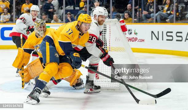 Claude Giroux of the Ottawa Senators battles in front of the net against Mark Jankowski and Juuse Saros of the Nashville Predators during an NHL game...