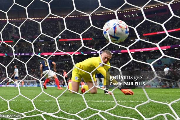 England's goalkeeper Jordan Pickford concedes a goal by France's midfielder Aurelien Tchouameni during the Qatar 2022 World Cup quarter-final...