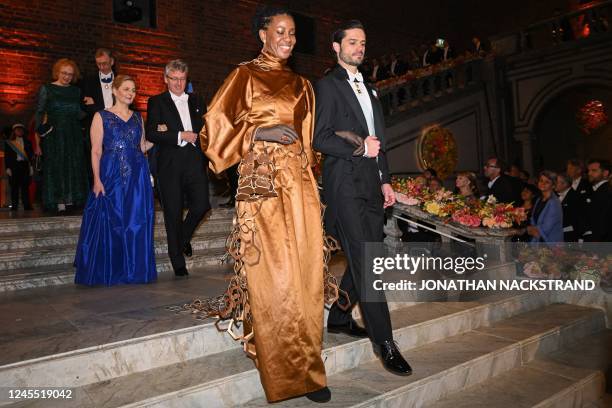 Phedria Marie St Hilaire and Prince Carl Philip of Sweden arrive at a royal banquet to honour the laureates of the Nobel Prize 2022, following the...