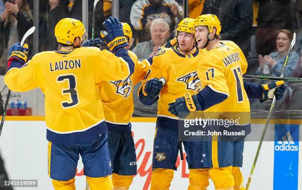 Yakov Trenin celebrates his goal with Mark Jankowski and Jeremy Lauzon of the Nashville Predators against the Ottawa Senators during an NHL game at...