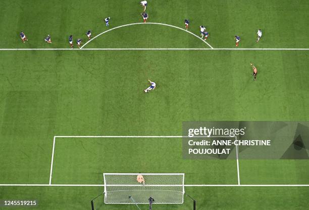 England's forward Harry Kane strikes the ball to score his team's first goal from the penalty spot during the Qatar 2022 World Cup quarter-final...