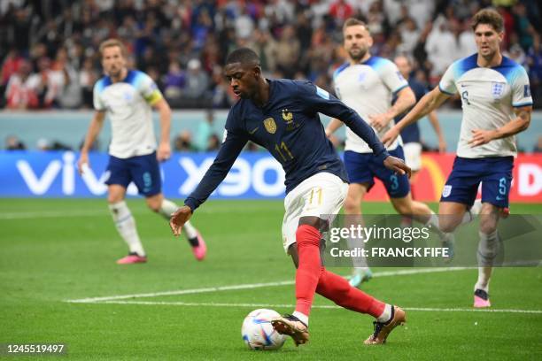 France's forward Ousmane Dembele runs with the ball during the Qatar 2022 World Cup quarter-final football match between England and France at the...