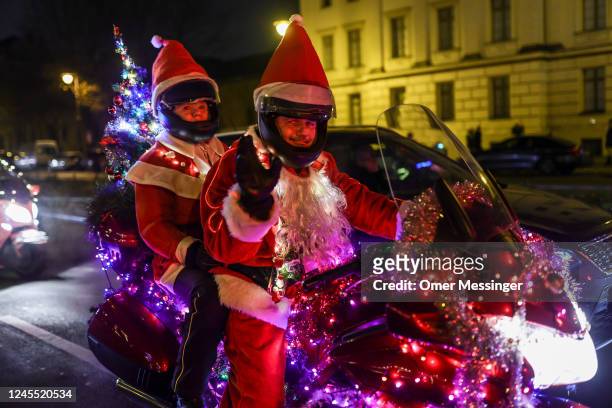 Motorcycle fans dressed as Santa Claus ride near Charlottenburg Palace during the 25th annual "Santa Claus On Road" Berlin Bike Tour, to deliver...