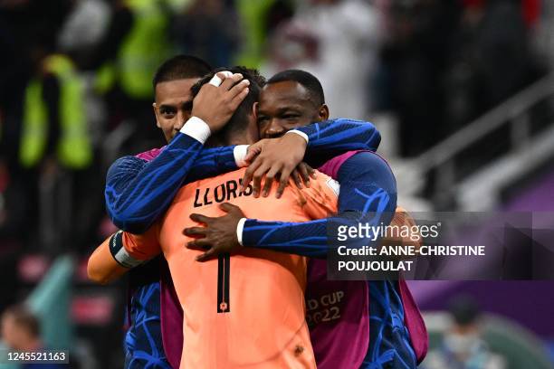 France's goalkeeper Hugo Lloris celebrates with France's goalkeeper Alphonse Areola and France's goalkeeper Steve Mandanda after they won the Qatar...