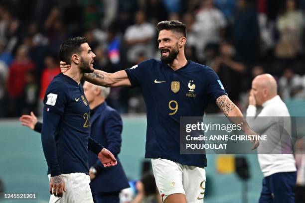 France's forward Olivier Giroud celebrates with France's defender Theo Hernandez after they won the Qatar 2022 World Cup quarter-final football match...