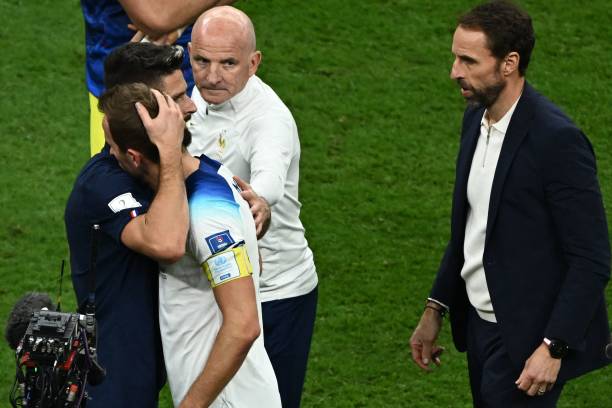 England's forward Harry Kane is comforted by France's forward Olivier Giroud , as England's coach Gareth Southgate looks on, after the the Qatar 2022...