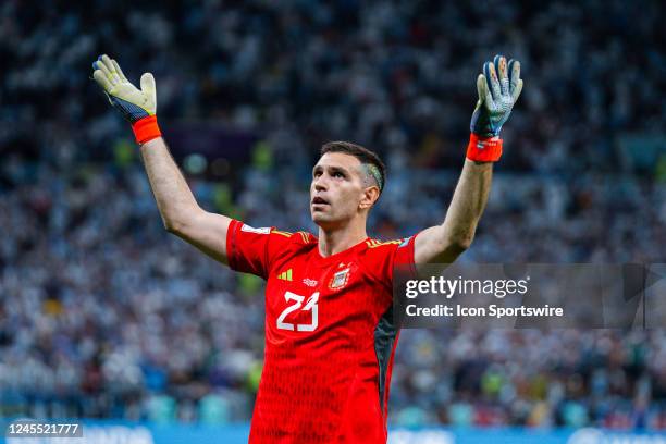 Argentina goalkeeper Emiliano Martinez celebrates making a save during the penalty kick shoot out at the end of the Quarterfinal match of the 2022...