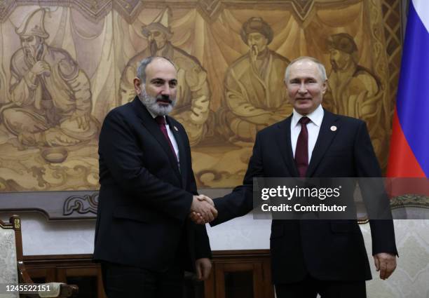 Russian President Vladimir Putin shakes hands with Armenian Prime Minister Nikol Pashinyan during their bilateral meeting at the Eurasian Economic...