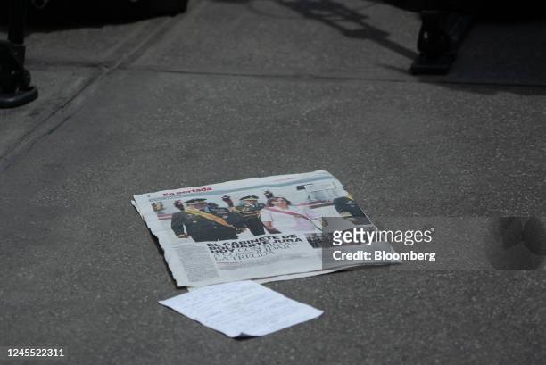 Newspaper with an article about the cabinet picks of Dina Boluarte, Peru's president, on the ground at the Government Palace before a swearing in...