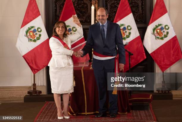 Dina Boluarte, Peru's president, left, shakes hands with Luis Fernando Elguero Gonzalez, Peru's new foreign trade and tourism minister, during a...