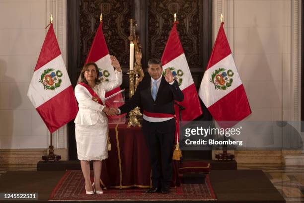 Dina Boluarte, Peru's president, left, shakes hands with Cesar Augusto Cervantes Cardenas, Peru's new interior minister, during a cabinet swearing in...
