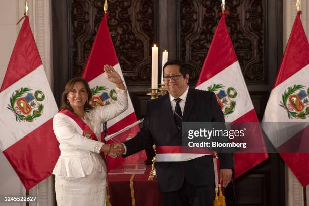 Dina Boluarte, Peru's president, left, shakes hands with Alex Contreras, Peru's new economy minister, during a cabinet swearing in ceremony at the...