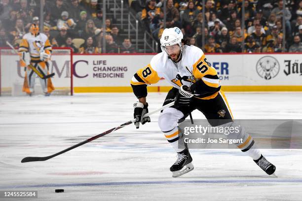 Kris Letang of the Pittsburgh Penguins handles the puck against the Buffalo Sabres at PPG PAINTS Arena on December 10, 2022 in Pittsburgh,...