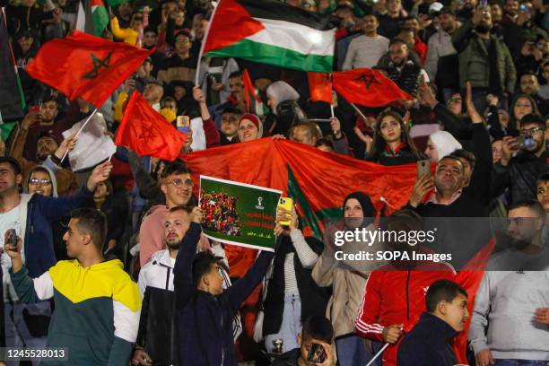 Palestinian supporters for Morocco's national football team celebrate in the occupied West Bank city of Nablus as they score the opening goal during...