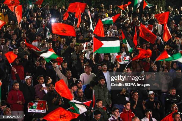 Palestinian supporters for Morocco's national football team celebrate in the occupied West Bank city of Nablus as they score the opening goal during...