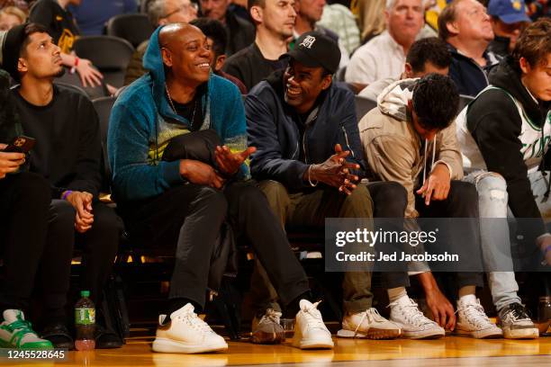 Dave Chappelle and Chris Rock look on during the game between the Boston Celtics and the Golden State Warriors on December 10, 2022 at Chase Center...