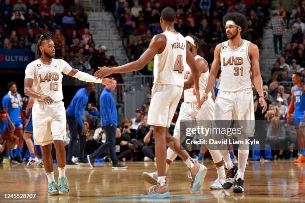 Darius Garland. Evan Mobley and Jarrett Allen of the Cleveland Cavaliers high five on the court during the game against the Oklahoma City Thunder on...