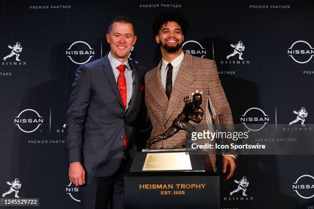 Head coach Lincoln Riley and Heisman Trophy winner Caleb Williams pose for photos during a press conference at the New York Marriott Marquis Astor...