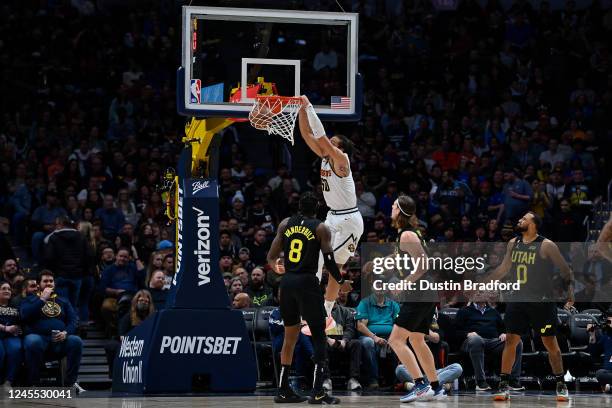 Aaron Gordon of the Denver Nuggets scores on a slam dunk in the second half during an NBA game at Pepsi Center on December 10, 2022 in Denver,...