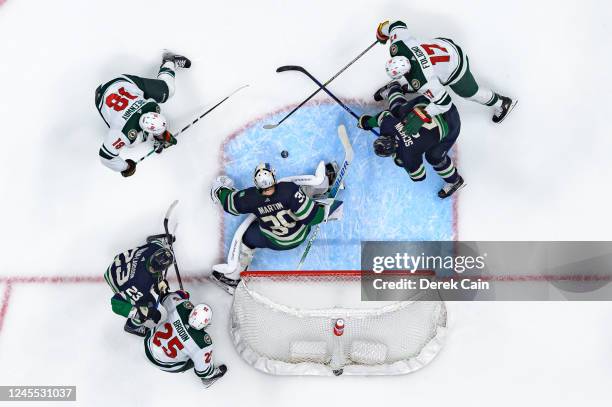 Oliver Ekman-Larsson Spencer Martin and Luke Schenn of the Vancouver Canucks defend against Jonas Brodin Jordan Greenway and Marcus Foligno of the...