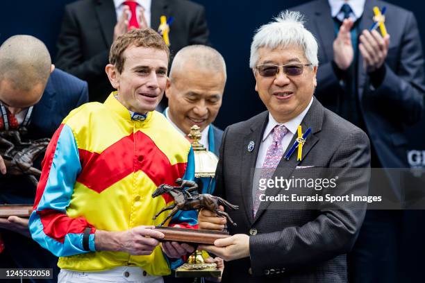Jockey Ryan Moore, who rides Wellington, poses for photo with trophy after winning the Longines Hong Kong Sprint of the Longines Hong Kong...