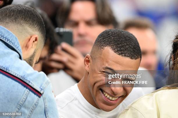 France's forward Kylian Mbappe laughs after winning the Qatar 2022 World Cup quarter-final football match between England and France at the Al-Bayt...